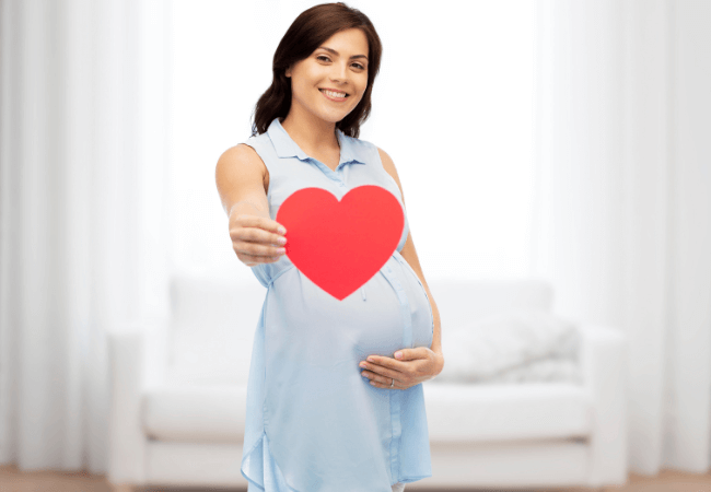 Pregnant woman with love card